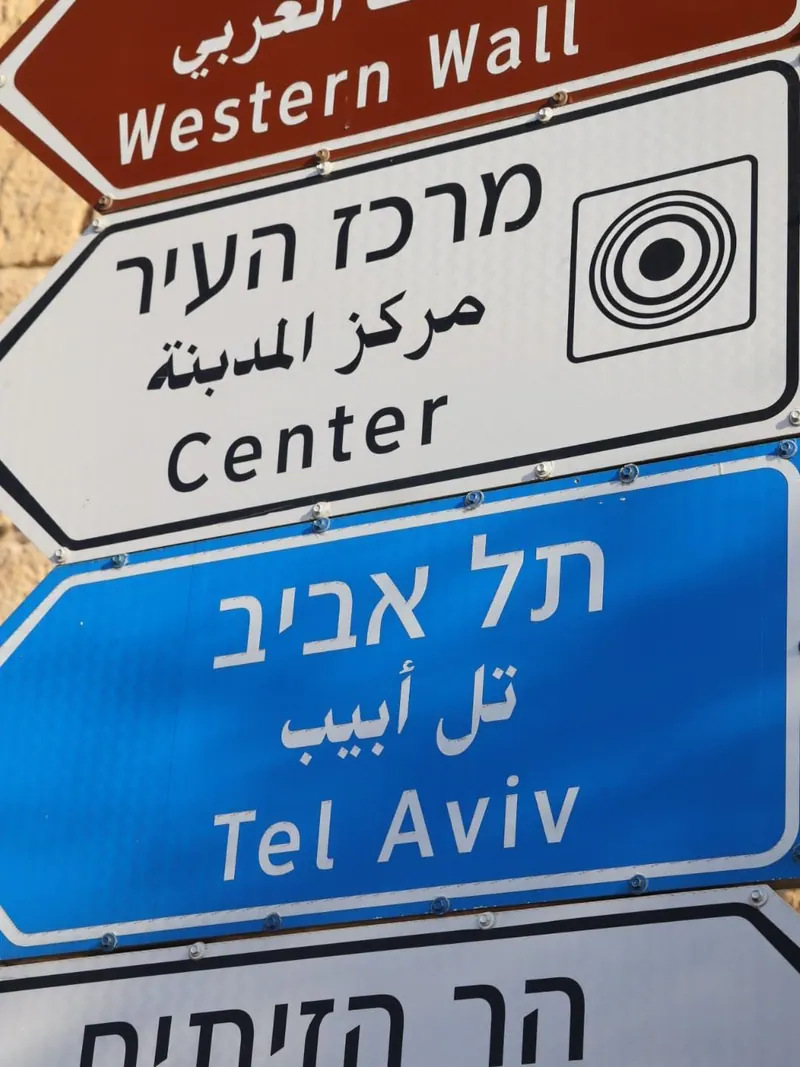 שלטי הכוונה בעברית, בערבית ובאנגלית: הכותל המערבי, מרכז העיר, תל אביב והר הזיתים.